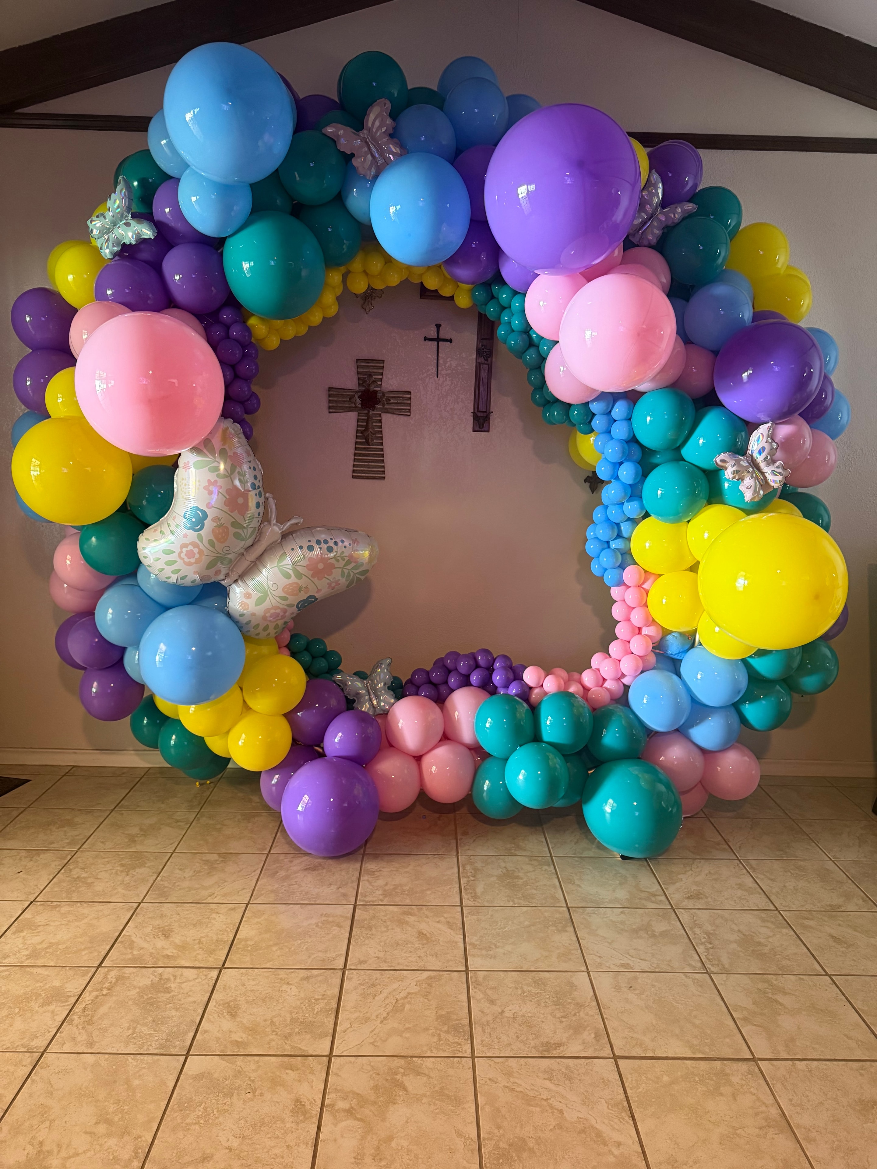 Teresa arranging a colorful balloon installation